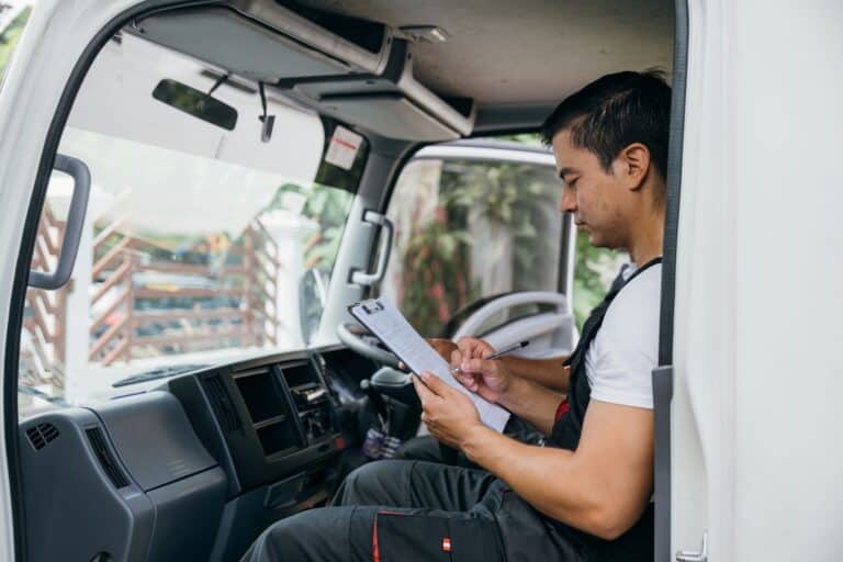 A side-view photo of the moving truck driver inside the truck