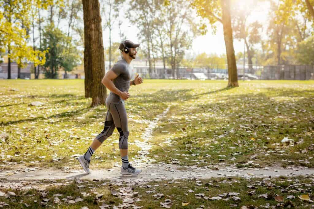 A man running at the park on a sunny day