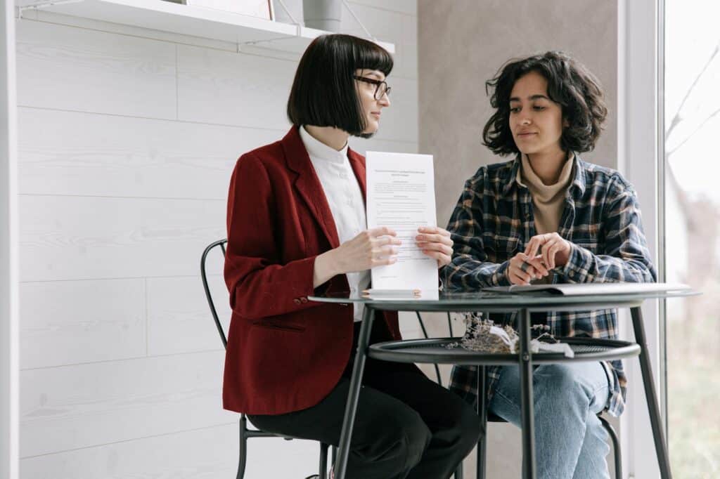 A female student is talking to a local estate agent