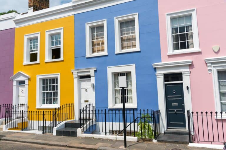 Colourful row of houses with railings in the concept of 'best affordable housing options in Fulham'.