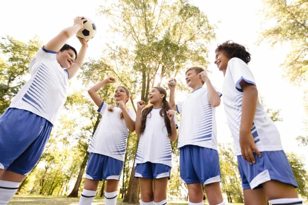 School kids in uniform ready to play football